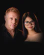 Tim and Paemi, who run Pattaya Insider, side by side in black.