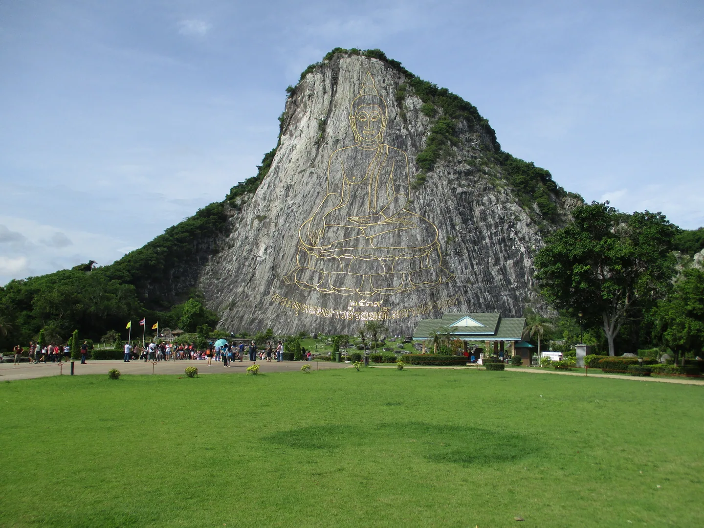 A golden outline of a seated Buddha covers the rock face at Khao Chi Chan.