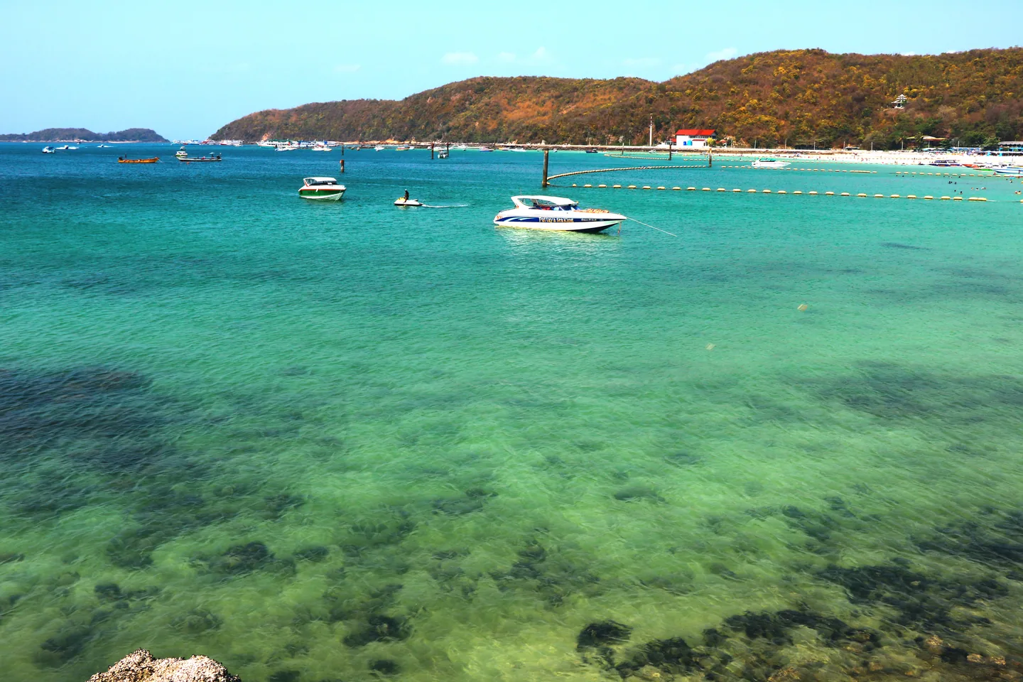 Clear water and boats off Tawaen Beach on Koh Larn.